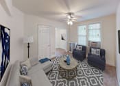 Thumbnail 7 of 29 - living area with large windows, sofa, coffee table, hardwood floors, and ceiling fan at parkside apartments in washington dc