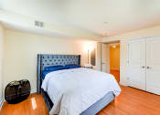 Thumbnail 10 of 20 - bedroom with bed, nightstand, large closet and view of bathroom at park vista apartments in washington dc