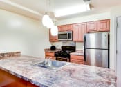 Thumbnail 4 of 20 - large kitchen with stainless steel appliances and large kitchen island at park vista apartments in washington dcl