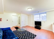 Thumbnail 5 of 20 - living area with sofa, credenza, tv, coffee table and window at park vista apartments in washington dc