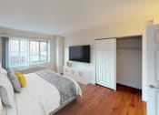 Thumbnail 8 of 13 - a bedroom with a bed and a tv on the wall