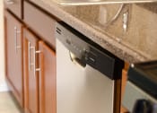 Thumbnail 3 of 13 - a dishwasher in a kitchen with a granite counter top at penn view apartments in washington dc