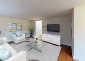 Thumbnail 5 of 13 - a living room with couches and a glass coffee table and a tv at penn view apartments in washington dc