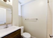 Thumbnail 14 of 28 - bathroom with sink, toilet, tub and large mirror at petworth station apartments in washington dc