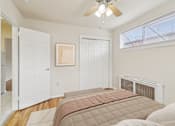 Thumbnail 3 of 17 - A bedroom with a large bed and a ceiling fan.