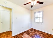 Thumbnail 15 of 22 - vacant bedroom with hardwood flooring, ceiling fan, window and view of hallway at richman apartments in Washington dc