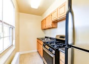 Thumbnail 2 of 22 - kitchen with stainless steel appliances and wood cabinetry at richman apartments in washington dc