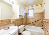 Thumbnail 17 of 22 - bathroom with vanity, toilet, tub and large mirror at richman apartments in washington dc