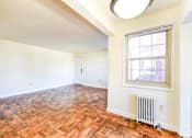 Thumbnail 14 of 22 - vacant living area with hardwood flooring and large windows at richman apartments in washington dc