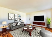 Thumbnail 4 of 22 - living area with sofa, coffee table, ottoman, credenza and tv at the richman apartments in congress heights washington dc