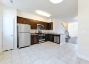 Thumbnail 3 of 14 - kitchen with espresso cabinetry, view of dining area and stainless steel appliances at sheridan station south townhomes in washington dc