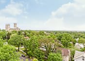 Thumbnail 18 of 24 - A castle sits atop a hill overlooking a residential neighborhood.