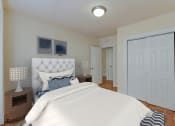 Thumbnail 5 of 20 - Bedroom with bed, nightstands, and large closet at sherry Hall apartments in washington dc