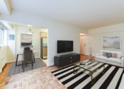 Thumbnail 2 of 20 - living area with sofa, coffee table, hardwood floors and view of dining area at sherry hall apartments in washington dc