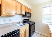 Thumbnail 2 of 21 - kitchen with gas range and window at shipley park apartments in shipley terrace washington dc