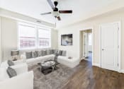Thumbnail 6 of 28 - living area with sofa, coffee table, sitting area, hardwood flooring, and ceiling fan petworth station apartments in washington dc