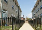 Thumbnail 14 of 15 - exterior brick walkway and leasing office at t street apartments in washington dc