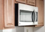 Thumbnail 2 of 15 - close up of microwave and cabinets in kitchen at t street apartments in washington dc