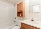 Thumbnail 10 of 15 - bathroom with tub, toilet, medicine cabinet, mirror and sink at t street apartments in washington dc