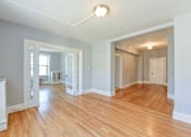 Thumbnail 7 of 21 - vacant living area with hardwood floors, french doors and view of foyerat the shawmut apartments in washington dc