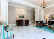 Thumbnail 20 of 25 - a lobby with a desk, chairs and a chandelier at the calverton apartment building in adams morgan washington dc