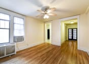 Thumbnail 8 of 21 - vacant living area with hardwood floors, ceiling fan and view of hallway and sunroom  at  the cortland apartments in washington dc