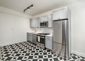Thumbnail 64 of 64 - A kitchen with a black and white checkered floor.