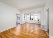 Thumbnail 56 of 64 - A room with wooden floors and white walls.