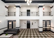 Thumbnail 51 of 64 - A black and white checkered floor in a spacious room.