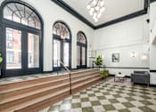 Thumbnail 52 of 64 - A black and white checkered floor in a room with a staircase.