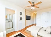 Thumbnail 8 of 22 - bedroom with bed, view of bathroom ceiling fan and hardwood floors at the foreland apartments in washinton dc