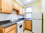 Thumbnail 5 of 22 - kitchen with gas range, wood cabinetry and energy efficient appliances at the foreland apartments in washinton dc