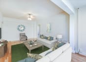Thumbnail 7 of 29 - living area with sofa, coffee table, sitting area, hardwood flooring, and ceiling fan at the frontenac apartments in washington dc