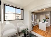 Thumbnail 5 of 21 - living area with seating, large windows and view of dining area at the shawmut apartments in washington dc