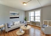 Thumbnail 4 of 21 - living area with sofa, coffee table , hardwood floors and large windows at the shawmut in washington dc