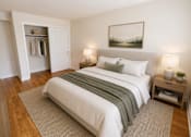 Thumbnail 10 of 20 - A bedroom with a large bed and a painting on the wall.