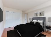 Thumbnail 7 of 15 - bedroom with bed, nightstand, large closet and wood floors at t street apartments in washington dc
