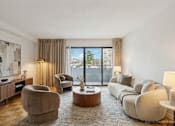 Thumbnail 18 of 36 - A modern living room with a large window and a view of a cityscape.
