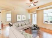 Thumbnail 2 of 39 - living area with large windows, sofa, coffee table, hardwood floors and view of sunroom at twin oaks apartments columbia heights washington dc