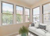 Thumbnail 7 of 39 - sunroom with sofa, coffee table and large windows at twin oaks columbia heights washington dc