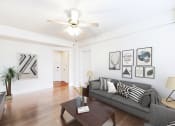 Thumbnail 4 of 28 - living area with sofa, coffee table, hardwood floors and ceiling fan at wakefield hall apartments in washington dc