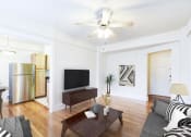 Thumbnail 5 of 28 - living area with sofa, coffee table, credenza, tv, hardwood floors, ceiling fan and view of kitchen at wakefield apartments in washington dc
