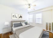 Thumbnail 6 of 28 - bedroom with bed, nightstands, hardwood floors, ceiling fan and large windows at wakefield hall apartments in washington dc