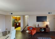 Thumbnail 3 of 27 - living room with credenza, tv, and view of dining area and kitchen at washington view apartments in southeast dc
