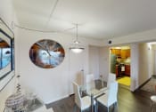Thumbnail 6 of 27 - Dining area with table, chairs, decorative lighting, mirror and view of kitchen at washington view apartments in southeast dc