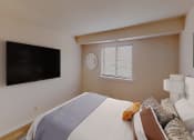 Thumbnail 20 of 27 - Bedroom with dresser, tv, bed and large windows at washington view apartments in southeast dc