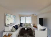 Thumbnail 17 of 27 - living area with sofa, coffee table, credenza, tv and large windows at washington view apartments in southeast dc