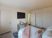 Thumbnail 12 of 27 - Bedroom with bed, dresser, tv, and closet at washington view apartments in washington dc