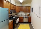 Thumbnail 2 of 27 - kitchen with stainless steel appliances at washington view apartments in southeast dc