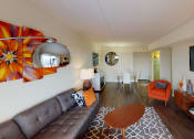 Thumbnail 7 of 27 - Livingroom with sofa. coffee table, decorative rug and view of front entrance at washington view apartments in washington dc